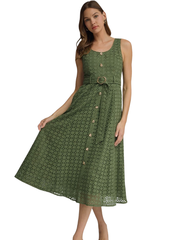Woman wearing a green dress with a belt on a white background