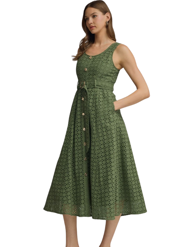 Woman wearing a green patterned dress on a white background