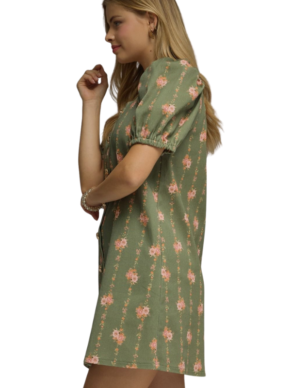 Woman wearing a green floral dress on a white background