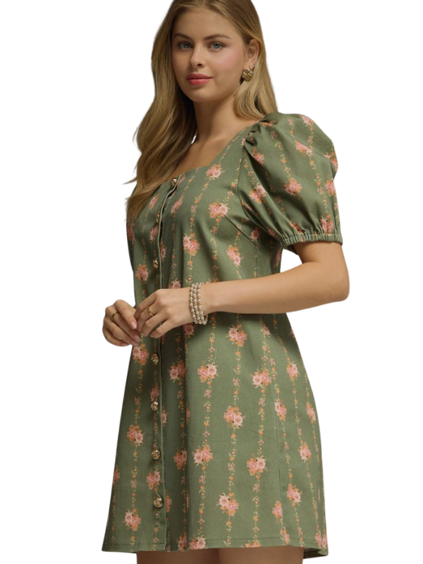 Woman wearing a green floral dress on a white background