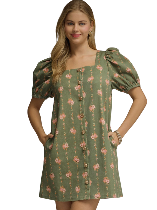 Woman wearing a green floral dress on a white background