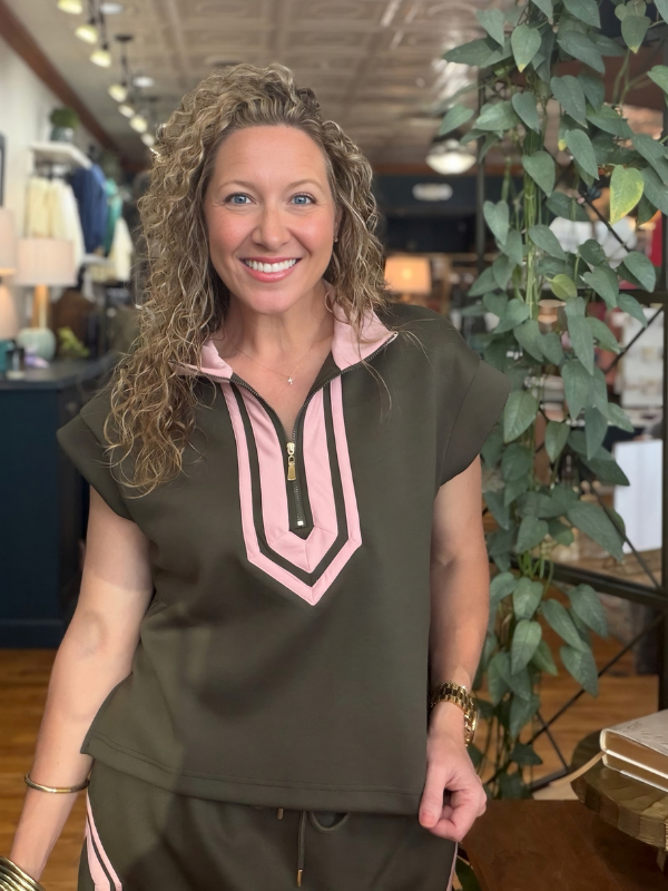 woman wearing a pink and olive green shirt and matching skirt 