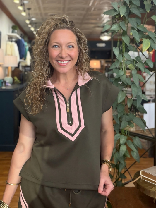 woman wearing a pink and olive green shirt and matching skirt 