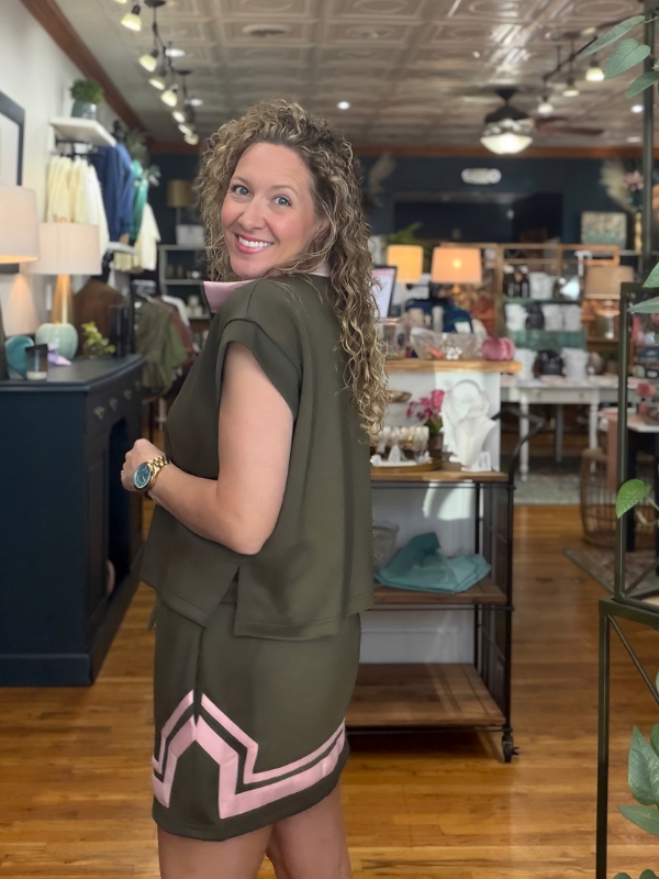 woman wearing a pink and olive green shirt and matching skirt 