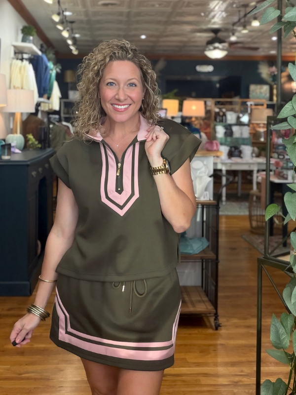 woman wearing a pink and olive green shirt and matching skirt 