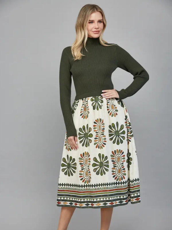 Woman wearing a green turtleneck and patterned skirt on a gray background