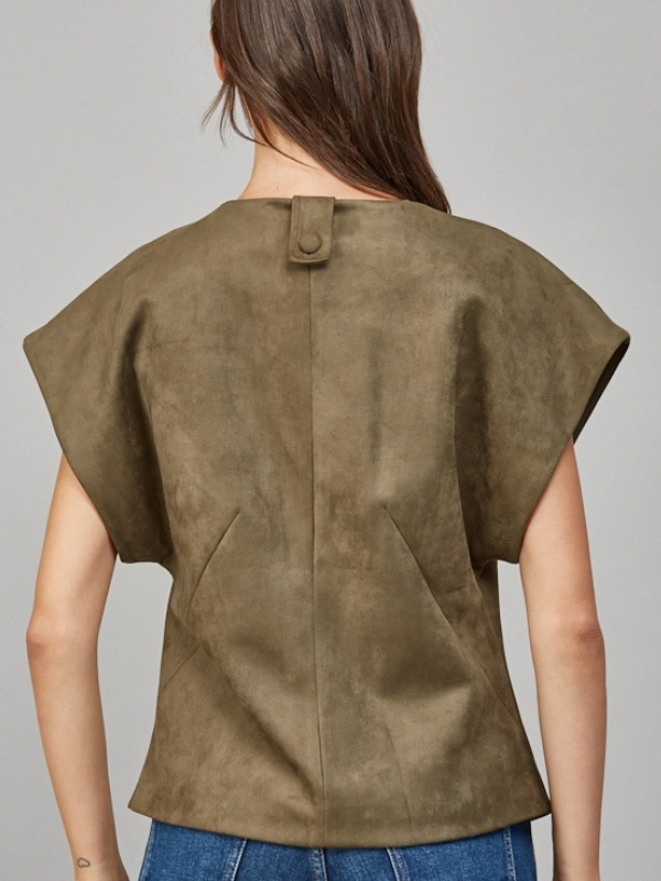 Brown suede top worn by a person on a gray background