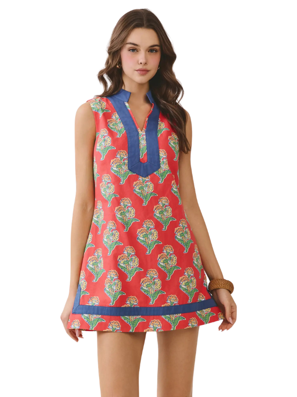 Woman wearing a colorful sleeveless dress with a white background