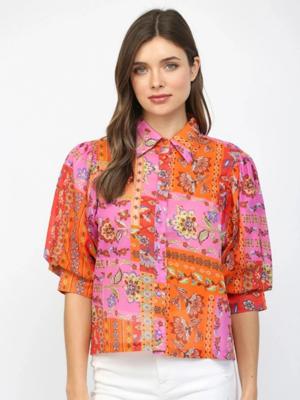 Woman wearing a colorful patterned shirt on a white background