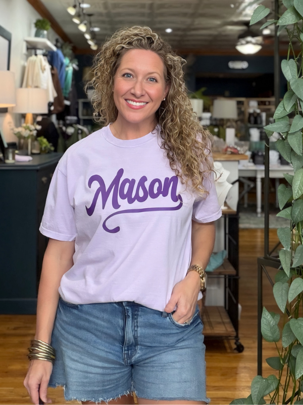 woman wearing a lilac tee that says Mason in dark purple ink 