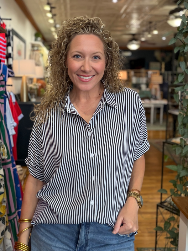 Woman wearing a black and white striped shirt in a store setting