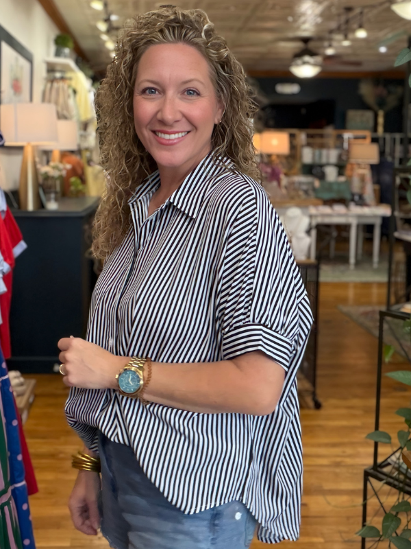 Woman wearing a striped shirt in a store setting