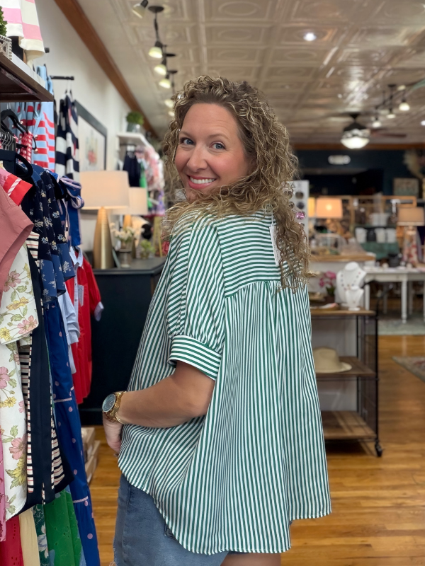 Woman in a striped shirt standing in a clothing store