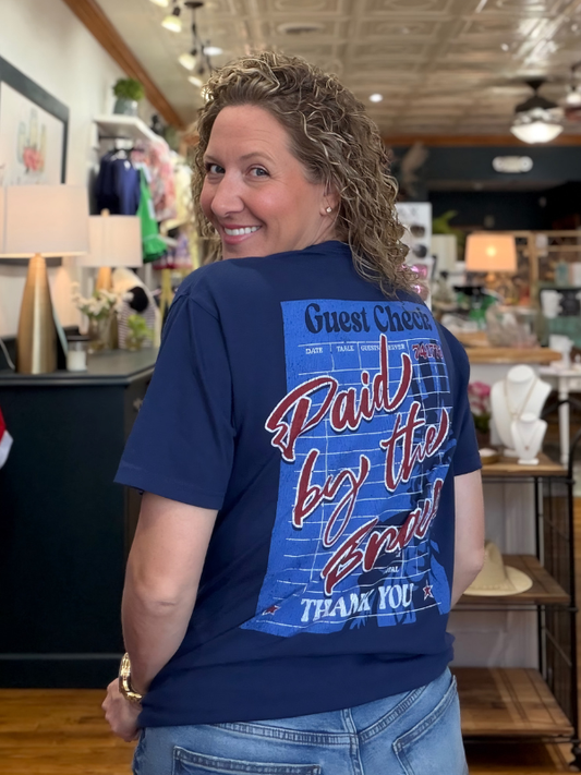 Woman wearing a blue t-shirt with text in a store setting