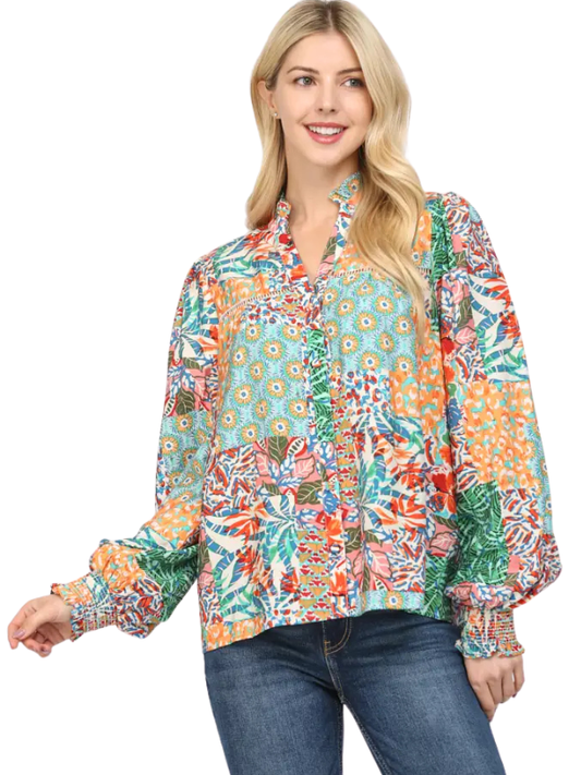 Woman wearing a colorful patterned blouse on a white background