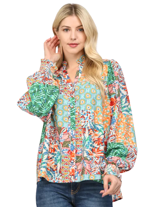 Woman wearing a colorful patterned blouse on a white background