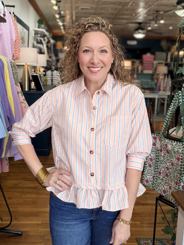 Woman wearing a striped shirt in a store setting