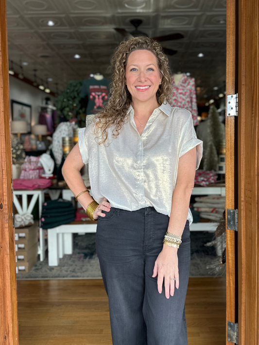Woman standing in a store with a neutral expression