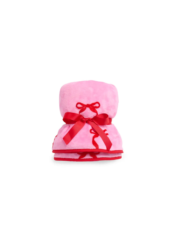 Pink hooded towel with a red bow on a white background