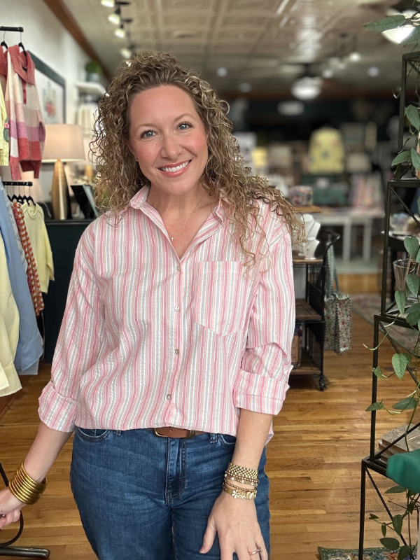 Woman wearing a striped shirt and jeans in a store setting