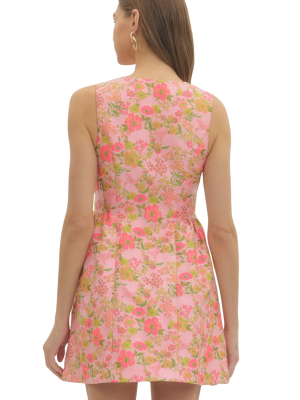 Woman wearing a pink floral dress on a white background