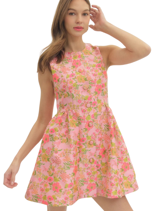 Woman wearing a pink floral dress on a white background