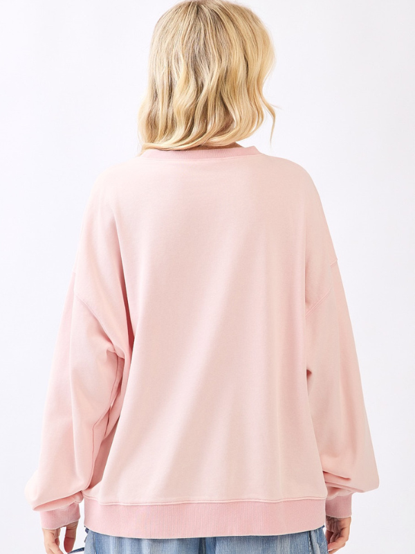 Person wearing a pink sweatshirt on a white background