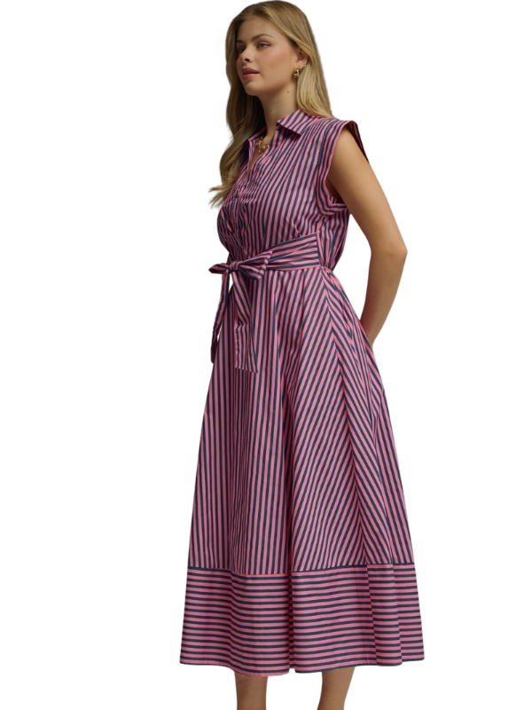 Woman wearing a pink and blue striped dress on a white background