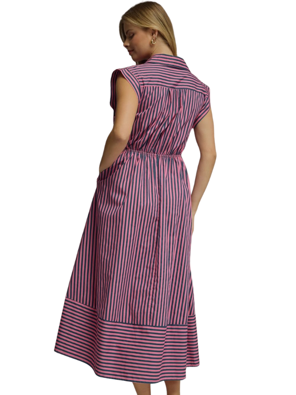 Woman wearing a pink and blue striped dress on a white background