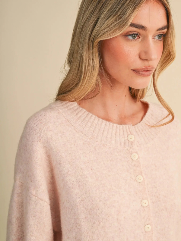 woman wearing a pink button sweater 