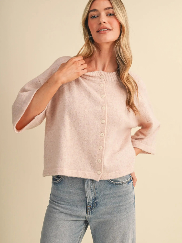 woman wearing a pink button sweater 
