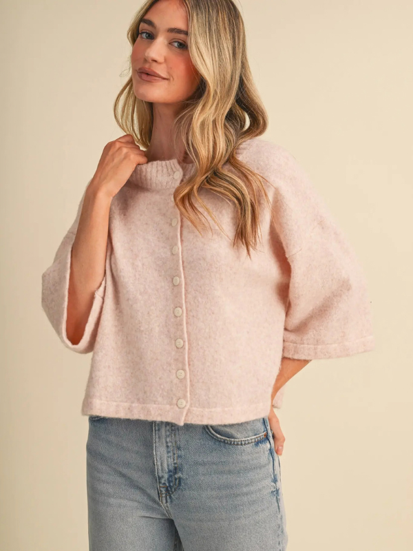 woman wearing a pink button sweater 