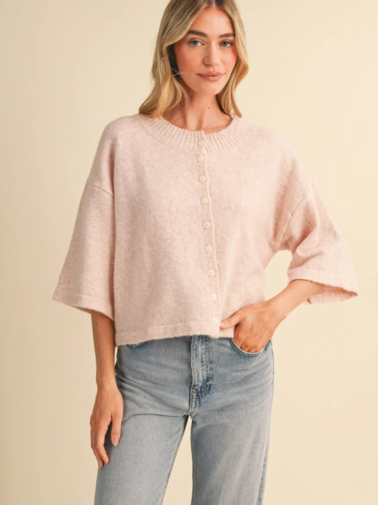woman wearing a pink button sweater 