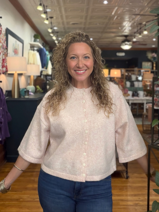 woman wearing a pink button sweater 