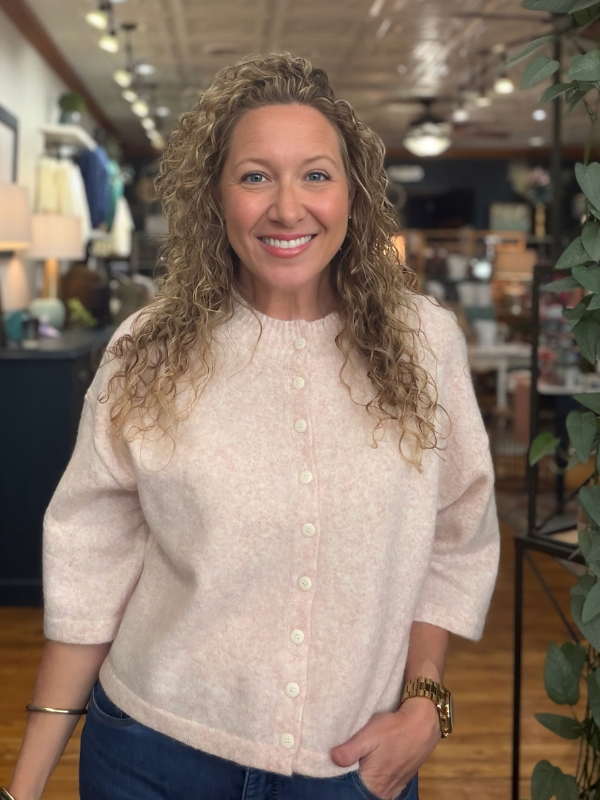 woman wearing a pink button sweater 