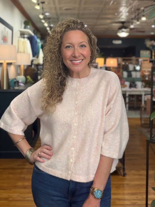 woman wearing a pink button sweater 