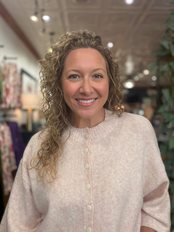 woman wearing a pink button sweater 