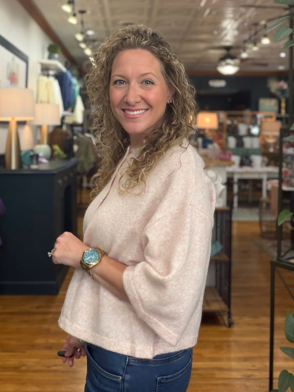 woman wearing a pink button sweater 