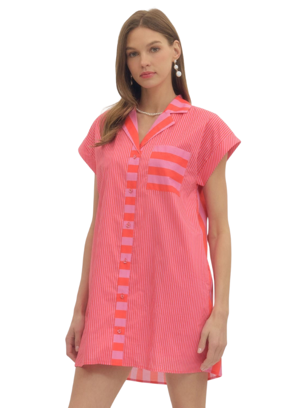 Woman wearing a pink dress with a pattern on a white background