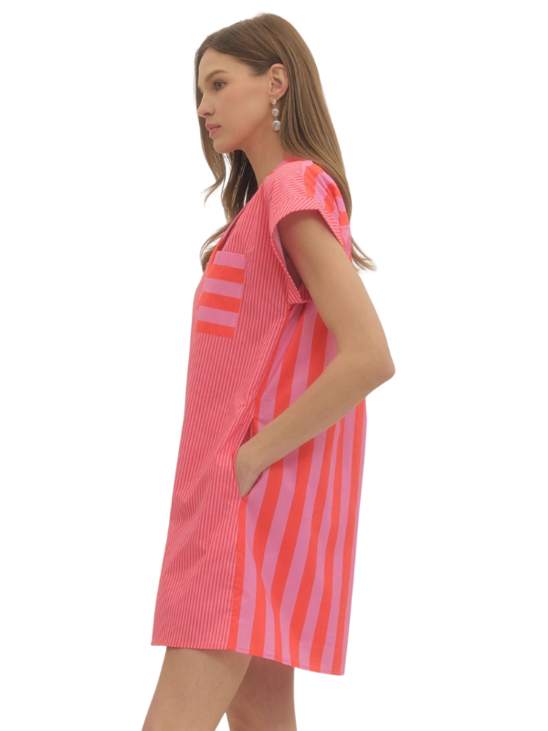 Woman wearing a pink and orange striped dress on a white background