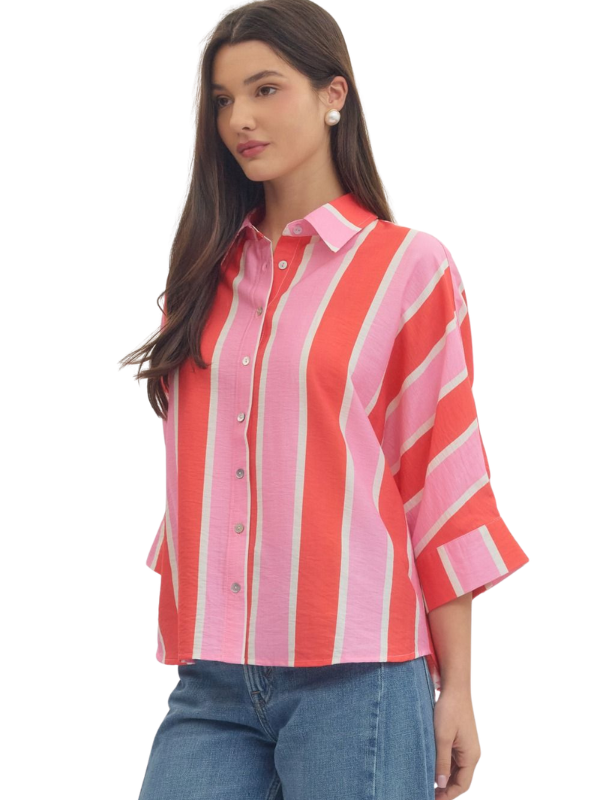 woman wearing a pink and orange striped button up top 