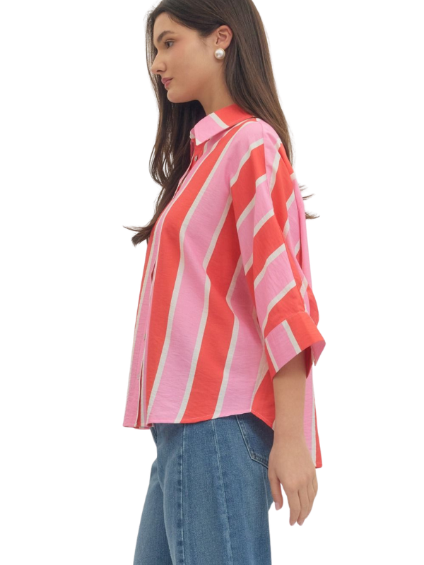 woman wearing a pink and orange striped button up top 