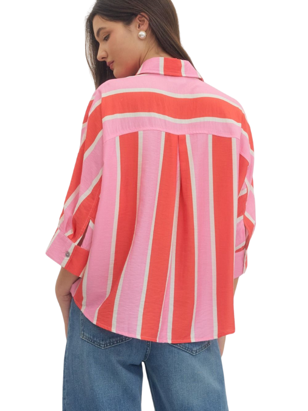 woman wearing a pink and orange striped button up top 