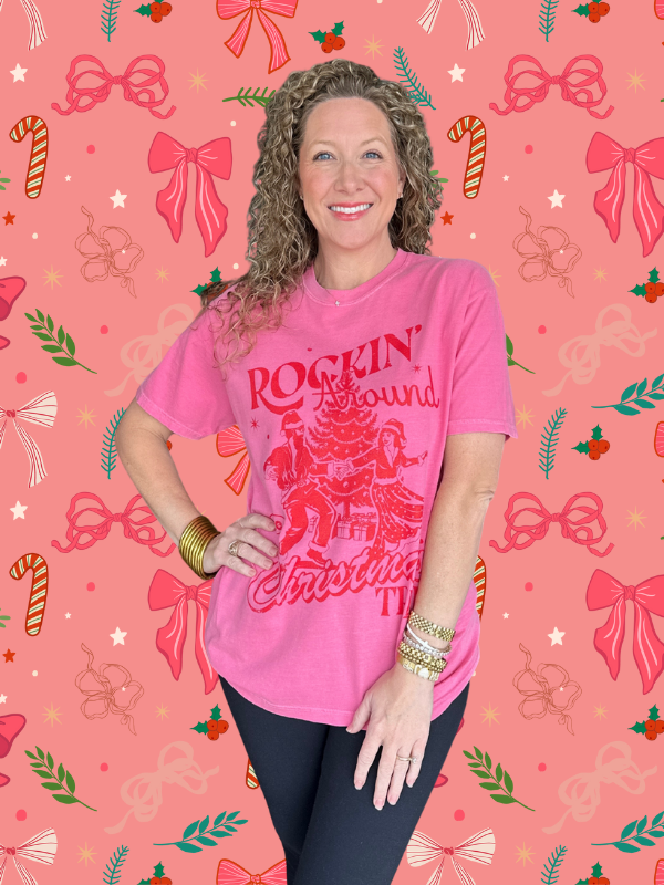 Woman wearing a pink 'Rockin' Around Christmas' shirt on a festive background with bows and candy canes.