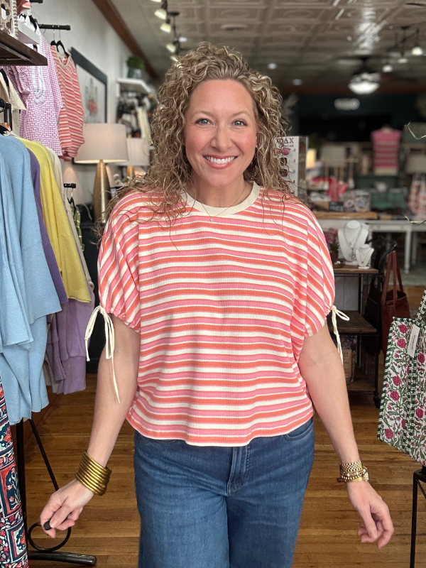 Woman wearing a striped shirt and jeans in a clothing store