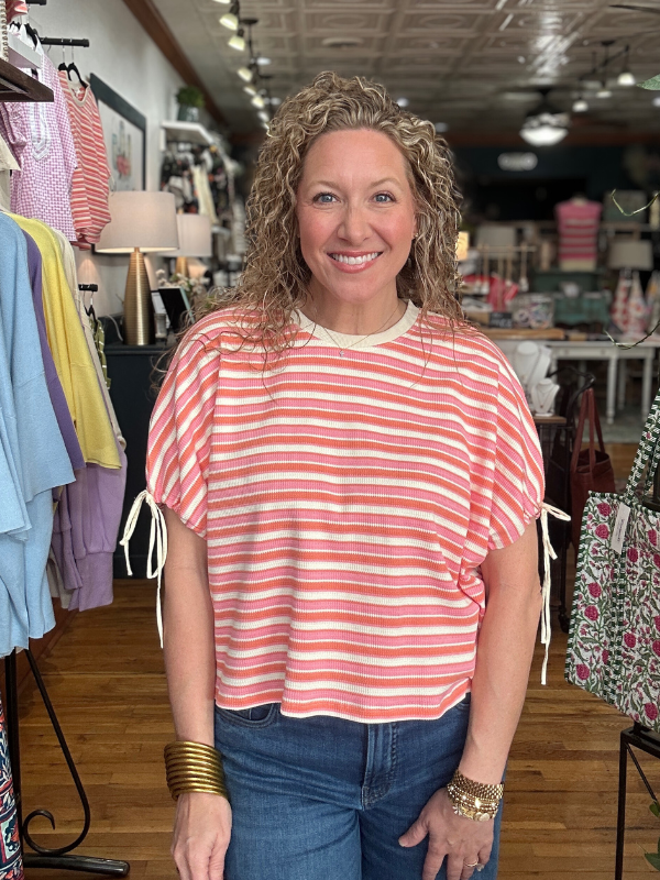 Woman wearing a red and white striped shirt in a store setting