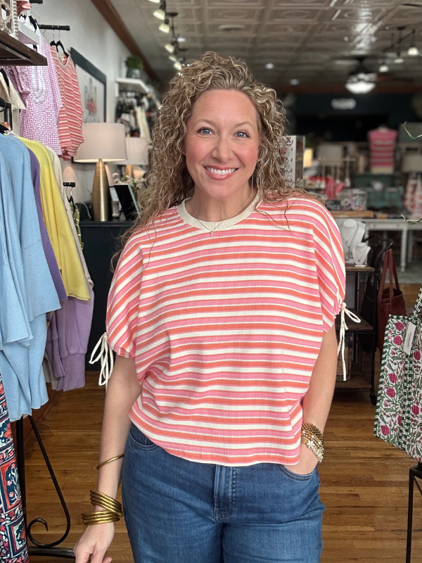 Woman wearing a red and white striped shirt in a clothing store