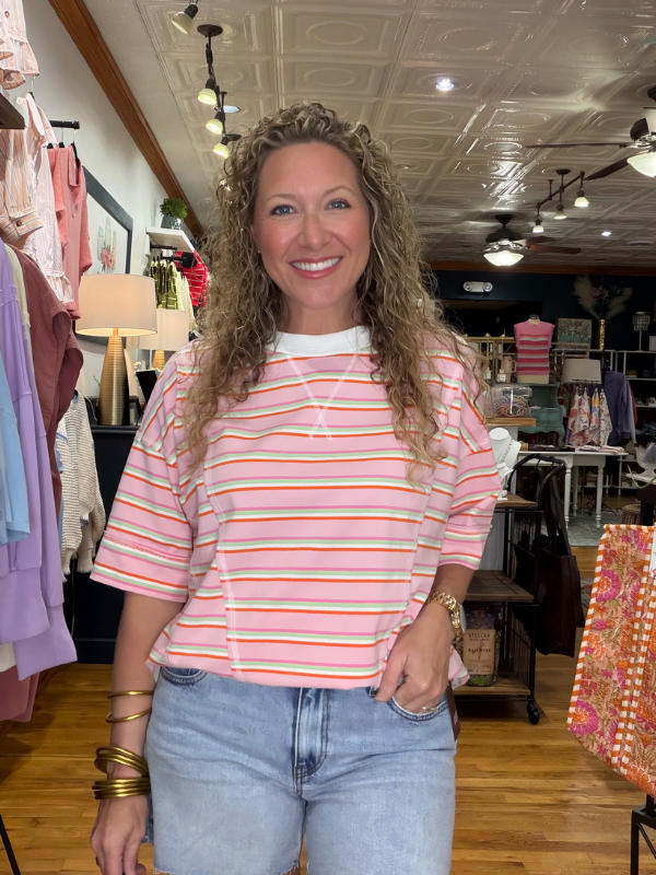 Woman wearing a striped shirt and jeans in a store setting