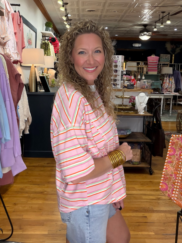 Woman in a striped shirt standing in a clothing store