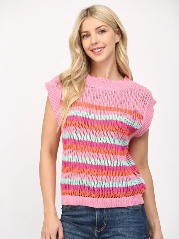 Woman wearing a colorful striped sweater against a white background